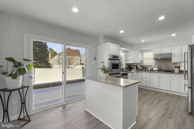 a living room with furniture a fireplace and a table