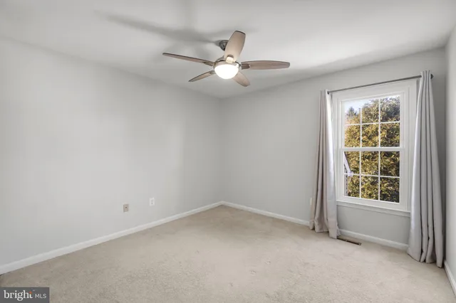 a view of a room with gym equipment and wooden floor