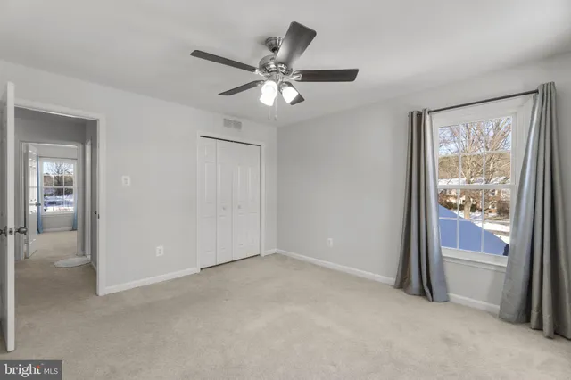 a view of a house with a yard and wooden fence