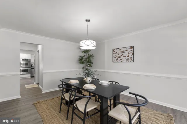 a dining room with furniture and chandelier