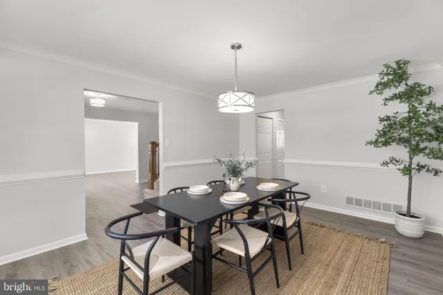 a view of a dining room with furniture wooden floor and chandelier