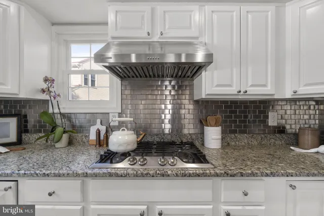 a kitchen with refrigerator and window