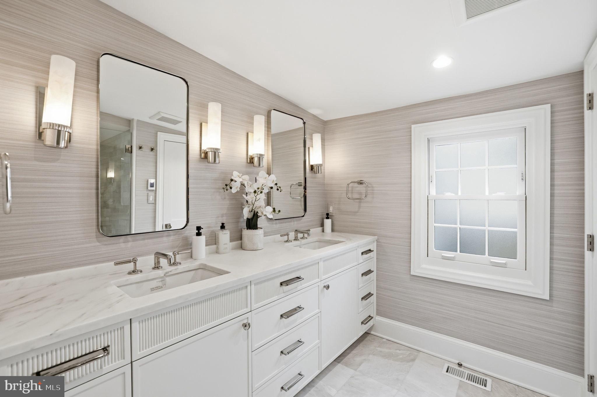 3418 Reservoir Road Northwest Washington, DC 20007 - Photo 19 of 33 a bathroom with double vanity sink and a mirror