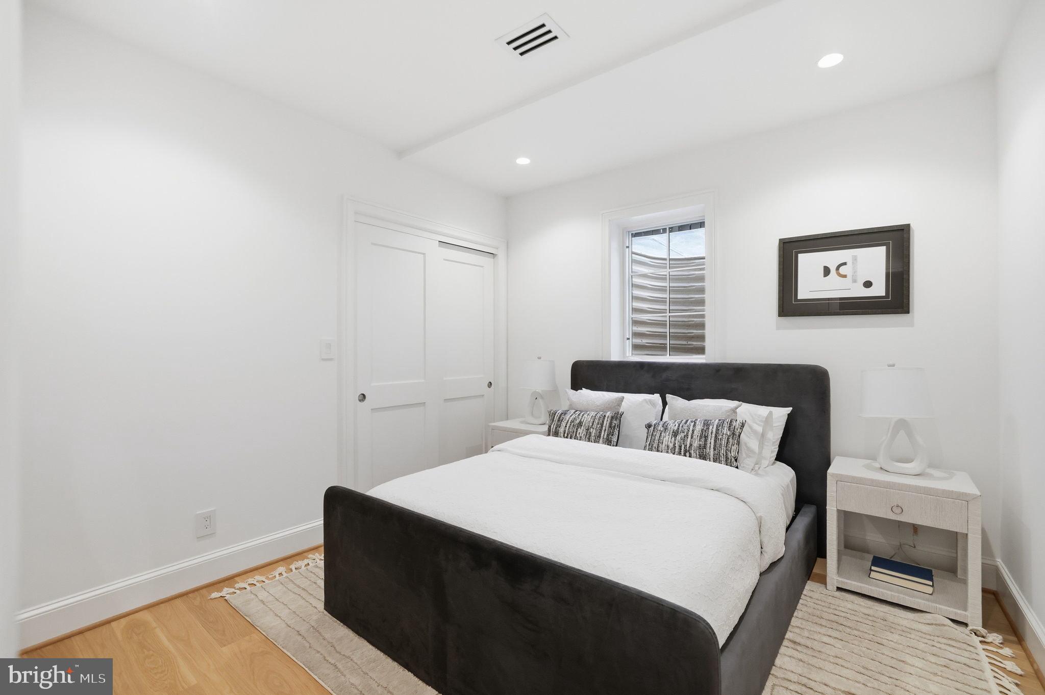 3418 Reservoir Road Northwest Washington, DC 20007 - Photo 28 of 33 a bedroom with a bed and a painting on the wall