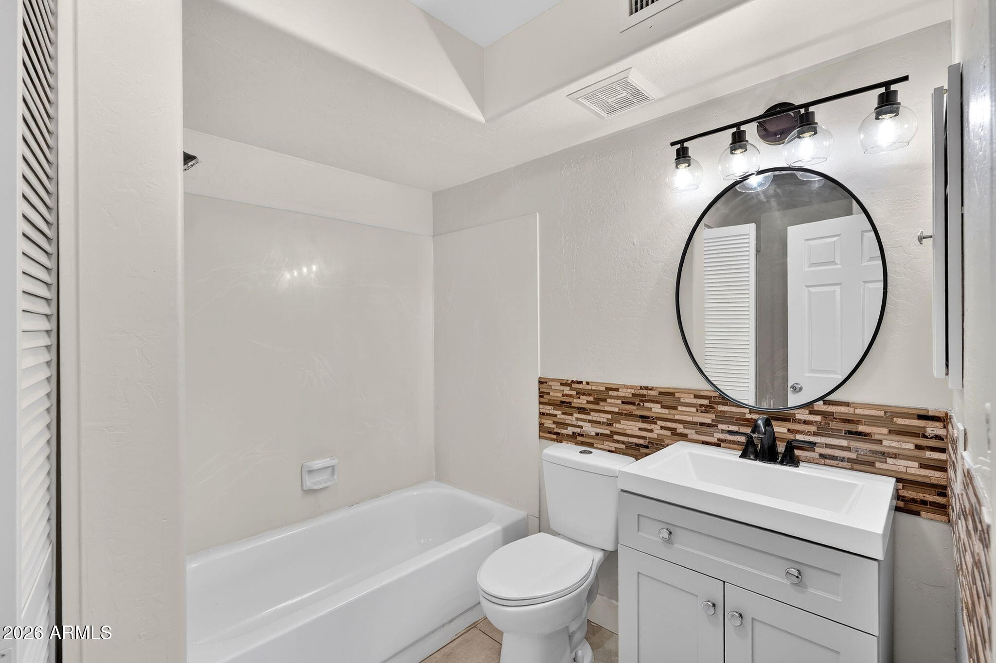 1417 East Mineral Road Gilbert, AZ 85234 - Photo 47 of 59 a bathroom with a sink a toilet and a mirror