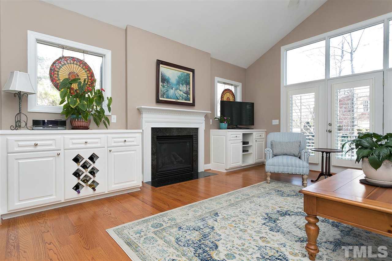 Vaulted Family Room with custom built-ins flanking gas Fireplace.