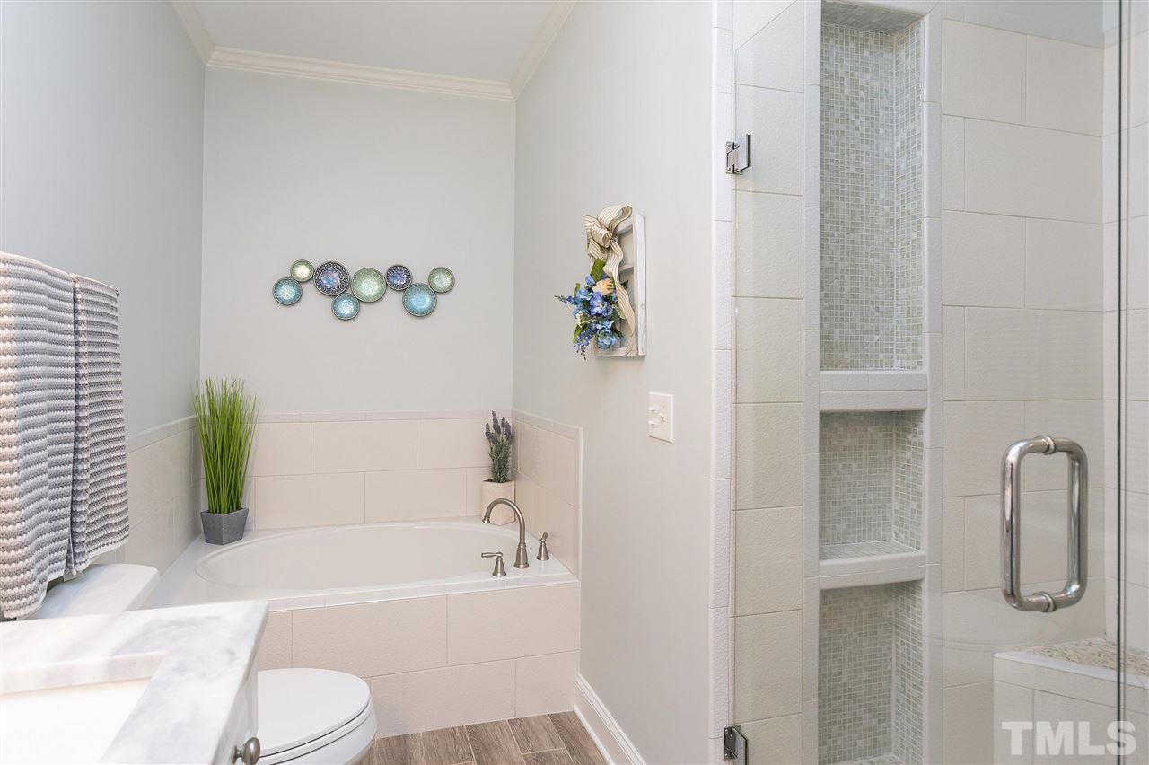 8216 Lloyd Allyns Way Raleigh, NC 27615 - Photo 11 of 30 Updated master bath with separate tub and shower. New tile, new fixtures.