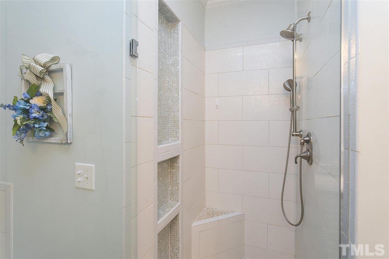 8216 Lloyd Allyns Way Raleigh, NC 27615 - Photo 13 of 30 Pretty tile detailing in the updated shower w frameless door.
