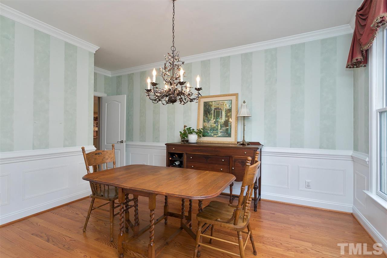 Separate dining room w wainscoting.