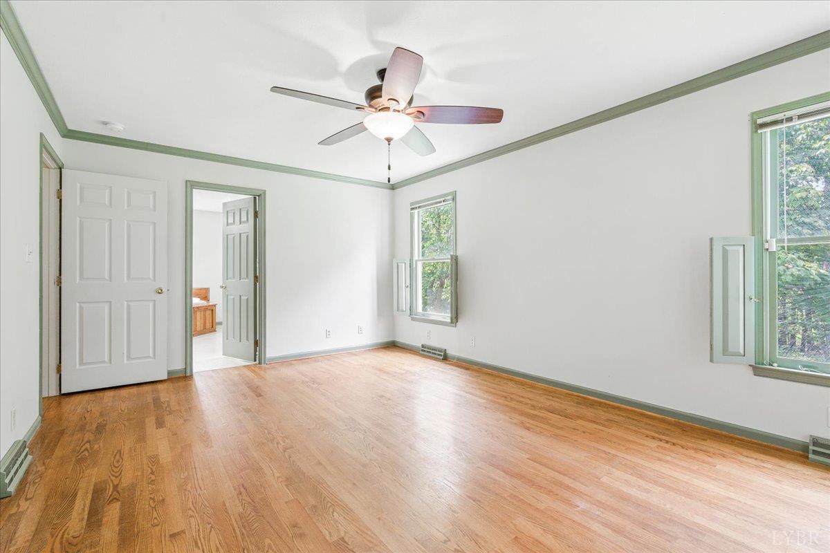 530 Patteson School Road Appomattox, VA 24522 - Photo 19 of 45 an empty room with wooden floor fan and windows