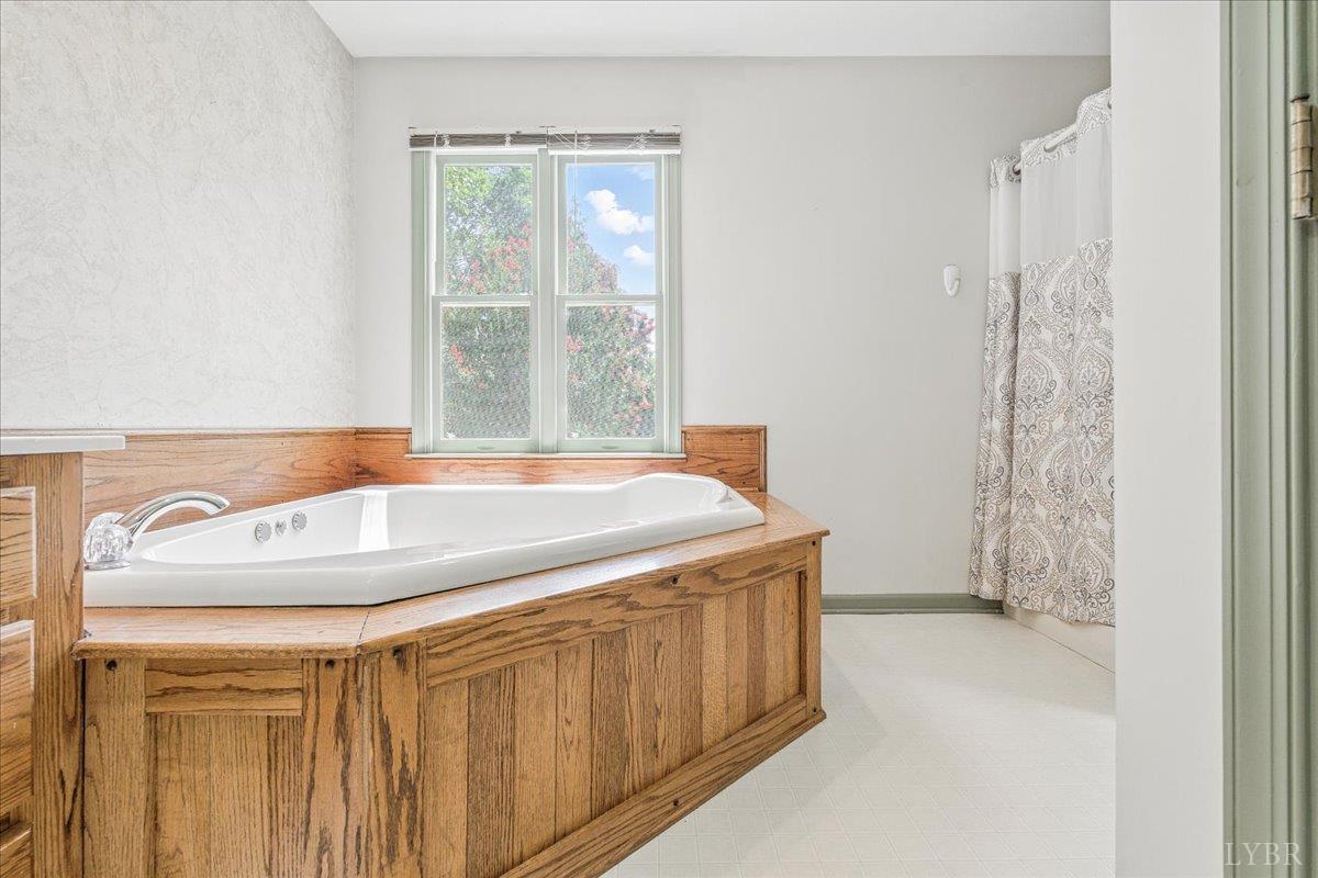 530 Patteson School Road Appomattox, VA 24522 - Photo 24 of 45 a bathroom with a granite countertop sink and a shower