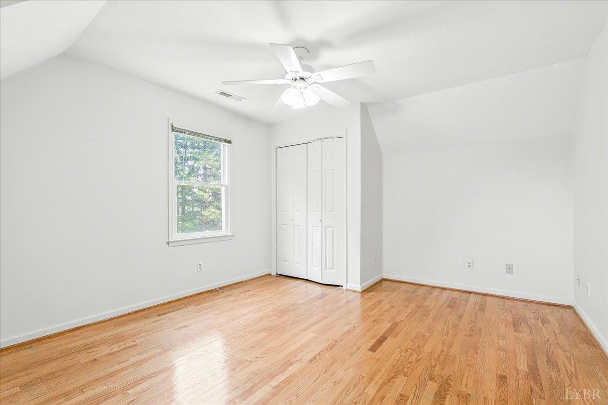 530 Patteson School Road Appomattox, VA 24522 - Photo 25 of 45 an empty room with wooden floor fan and windows