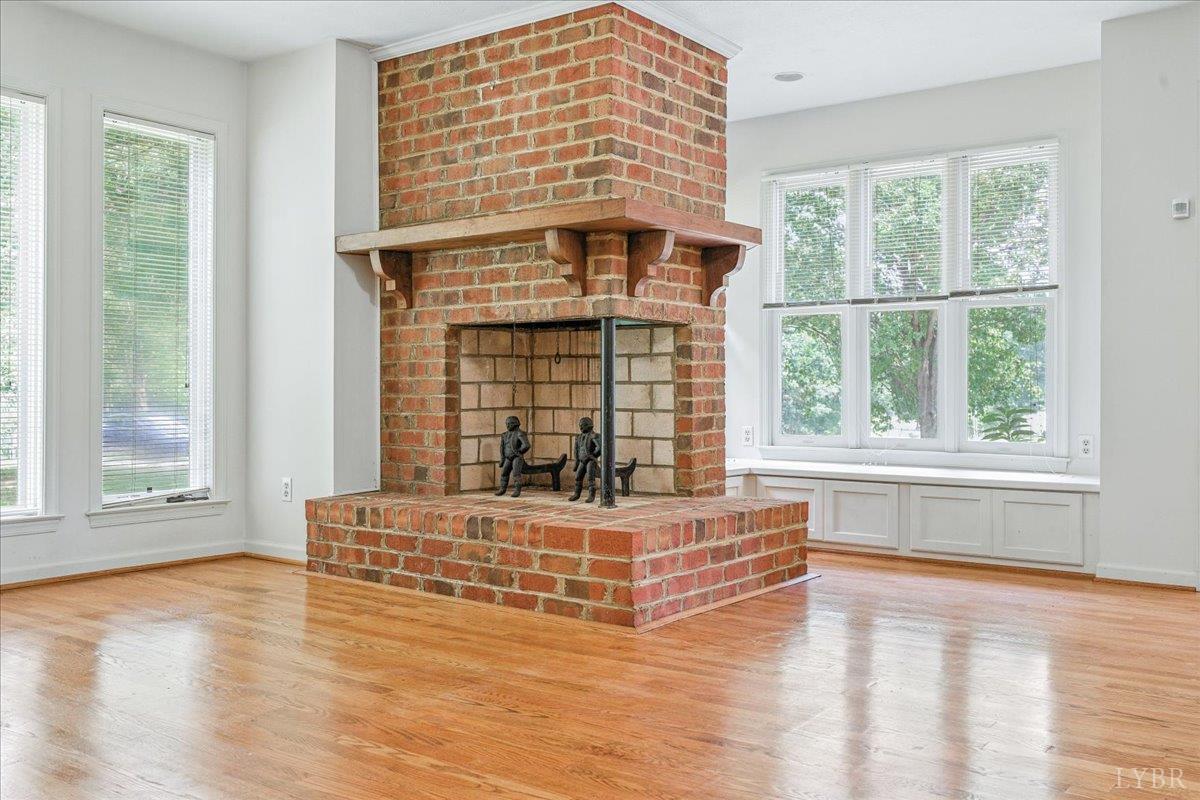 530 Patteson School Road Appomattox, VA 24522 - Photo 10 of 45 a living room with a fireplace and wooden floor