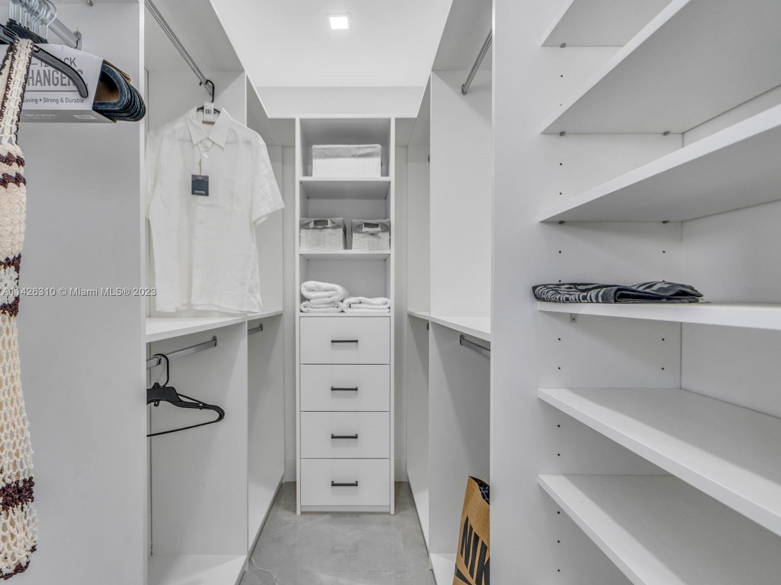 9670 Southwest 17th Street Miami, FL 33165 - Photo 12 of 17 a view of walk in closet with clothes and shoes