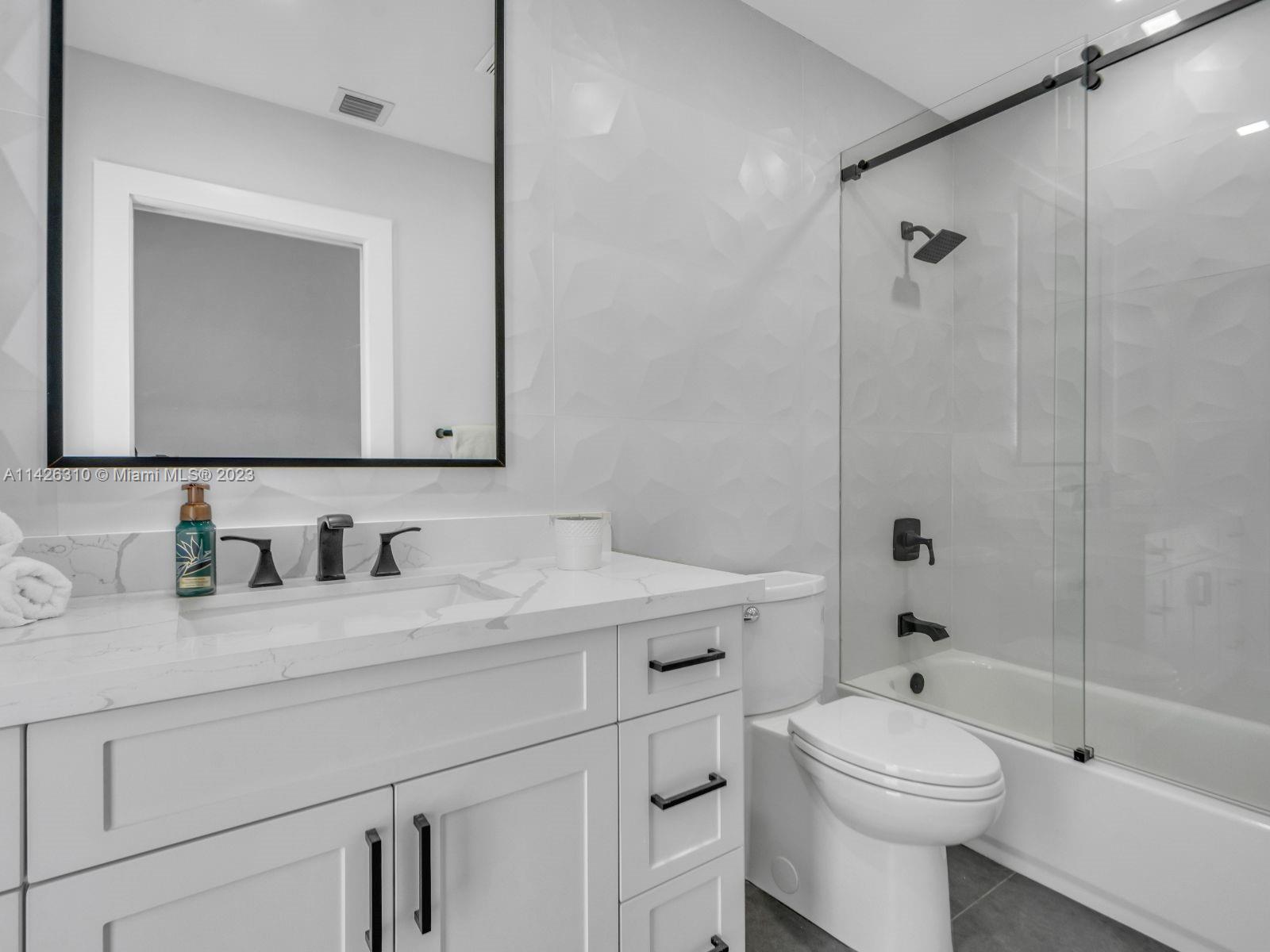 9670 Southwest 17th Street Miami, FL 33165 - Photo 15 of 17 a bathroom with a sink a toilet and shower