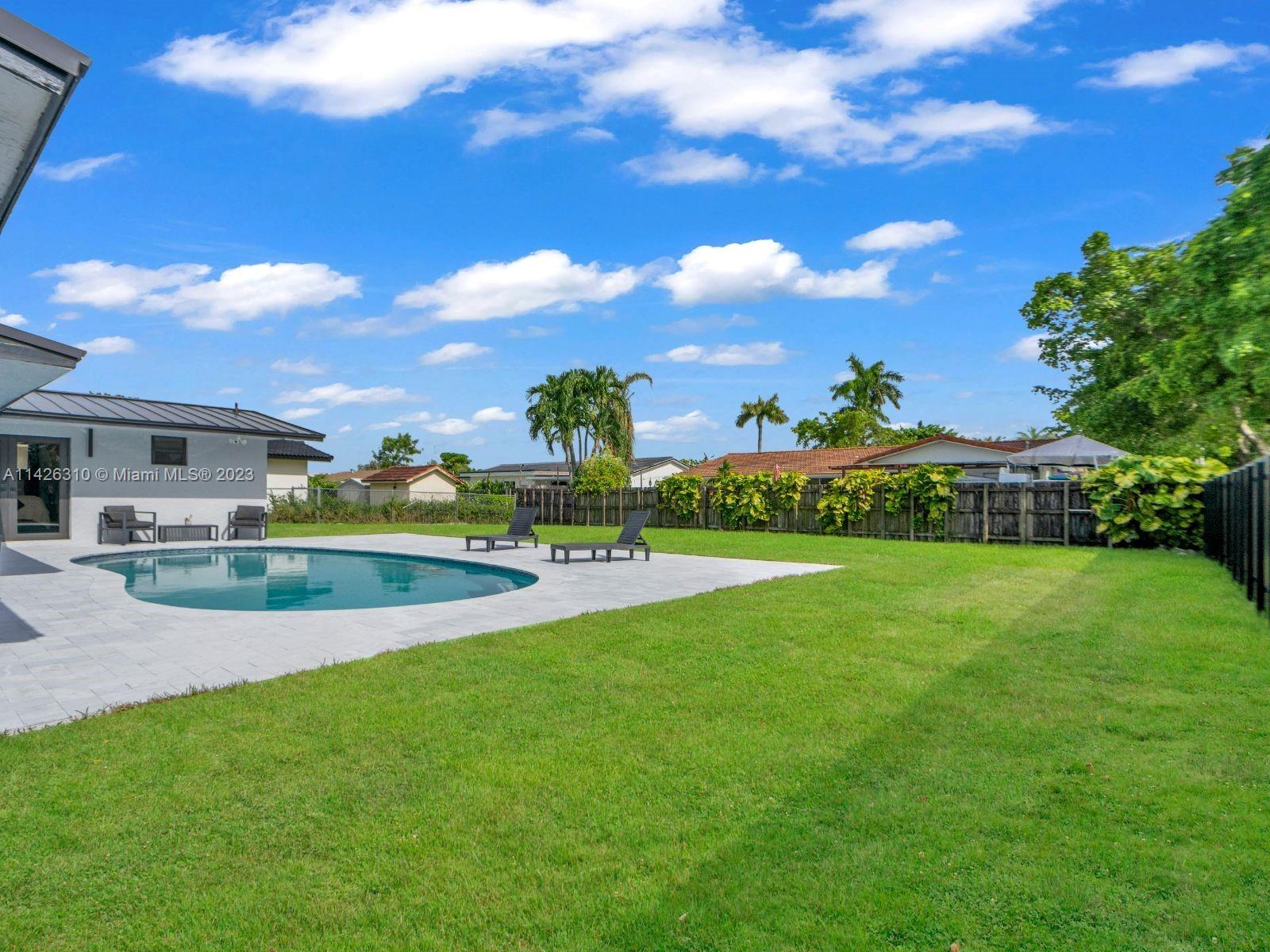 9670 Southwest 17th Street Miami, FL 33165 - Photo 16 of 17 a view of a house with a big yard