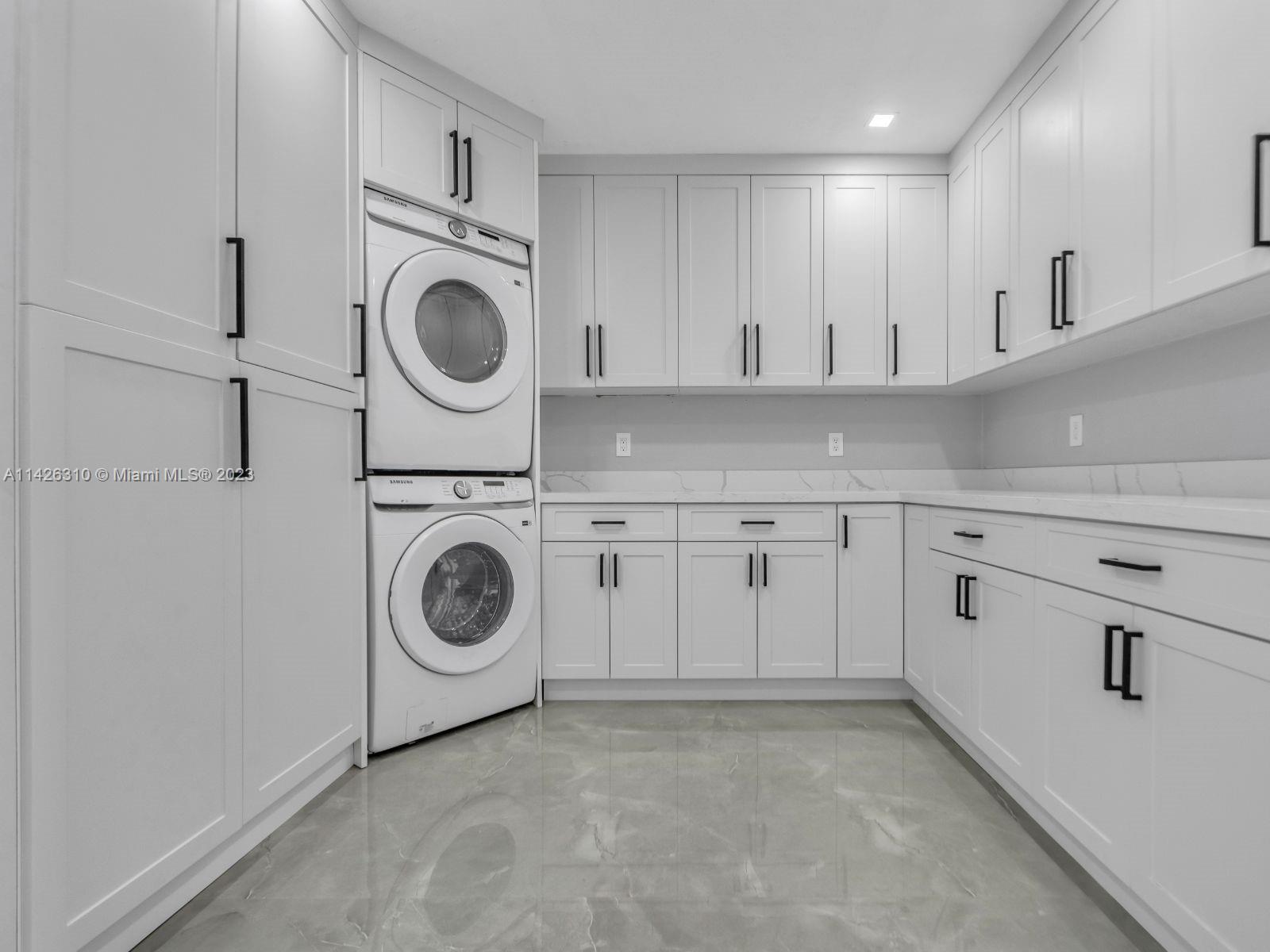 9670 Southwest 17th Street Miami, FL 33165 - Photo 8 of 17 a utility room with sink dryer and washer