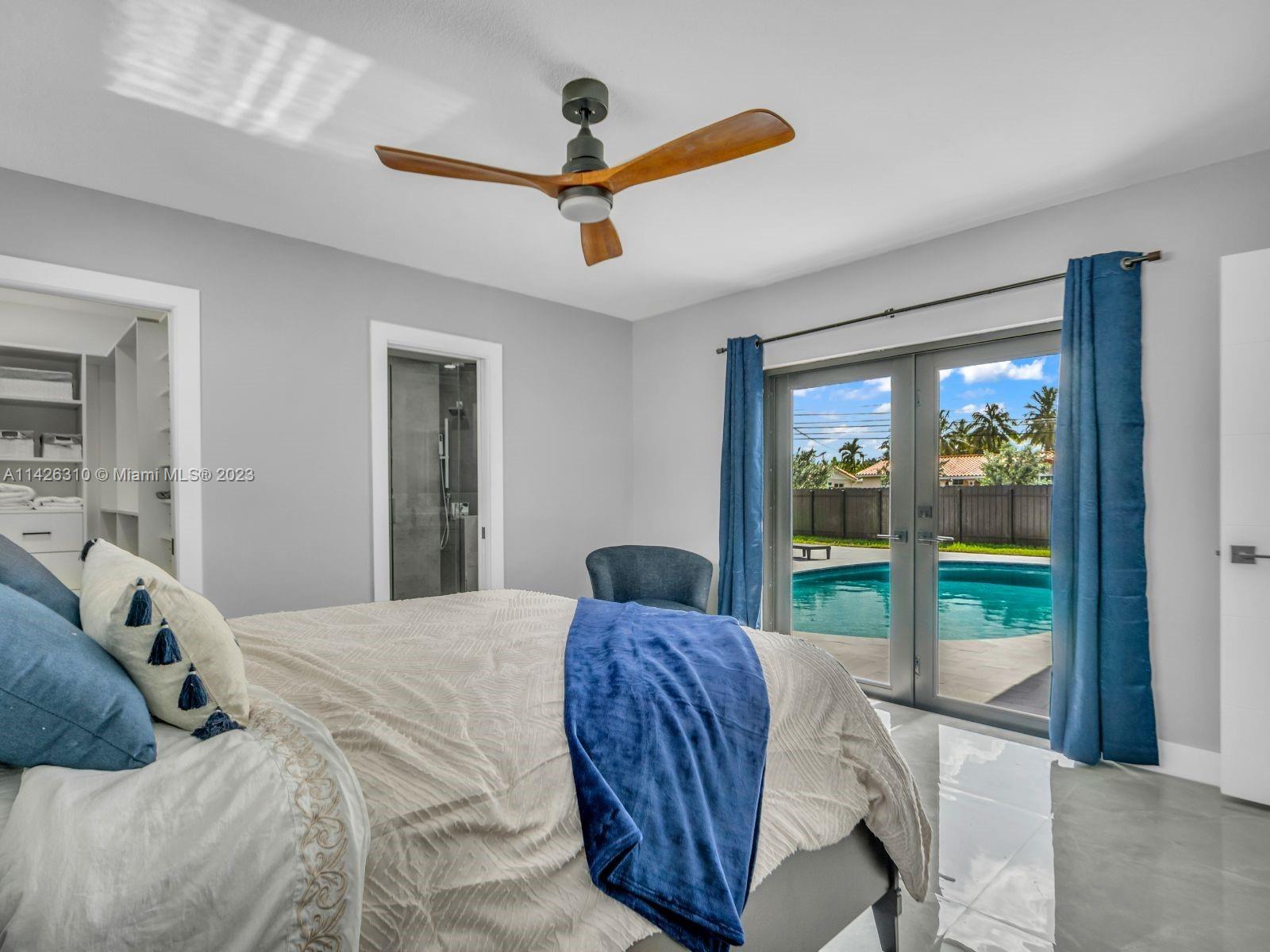 9670 Southwest 17th Street Miami, FL 33165 - Photo 9 of 17 a bedroom with a bed and a large window