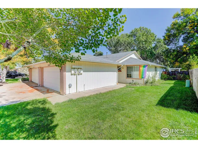 a aerial view of a house with a yard and a garage
