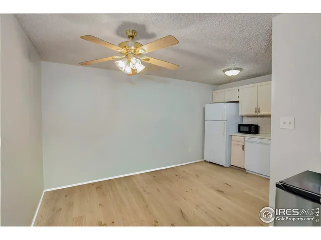 a view of kitchen with refrigerator and microwave