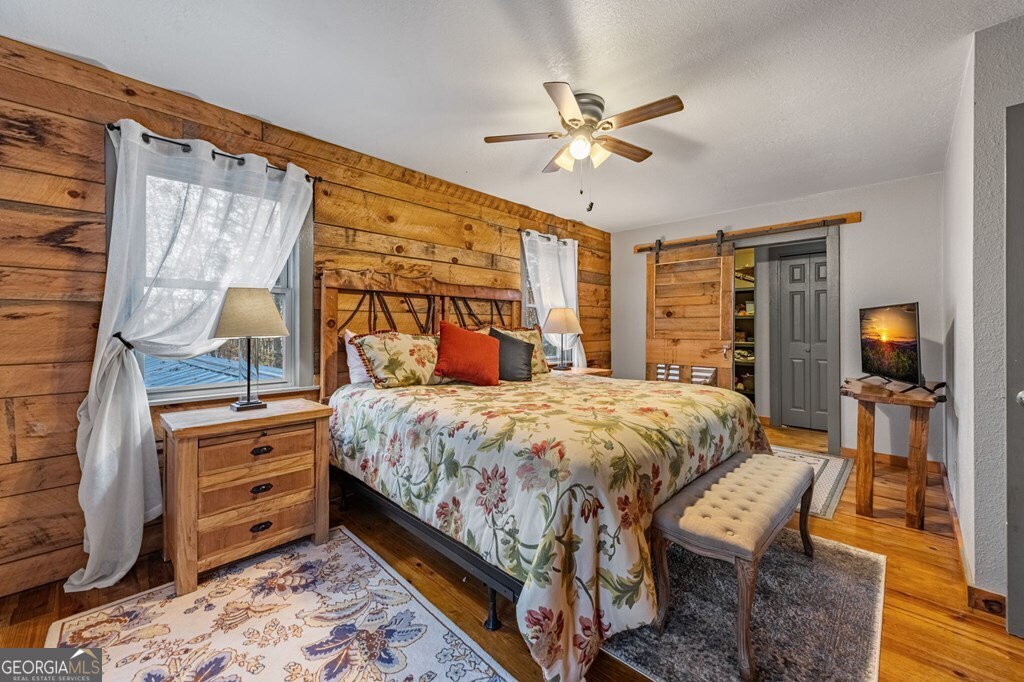 90 Hay Lane Morganton, GA 30560 - Photo 19 of 77 a bedroom with a bed and wooden floor