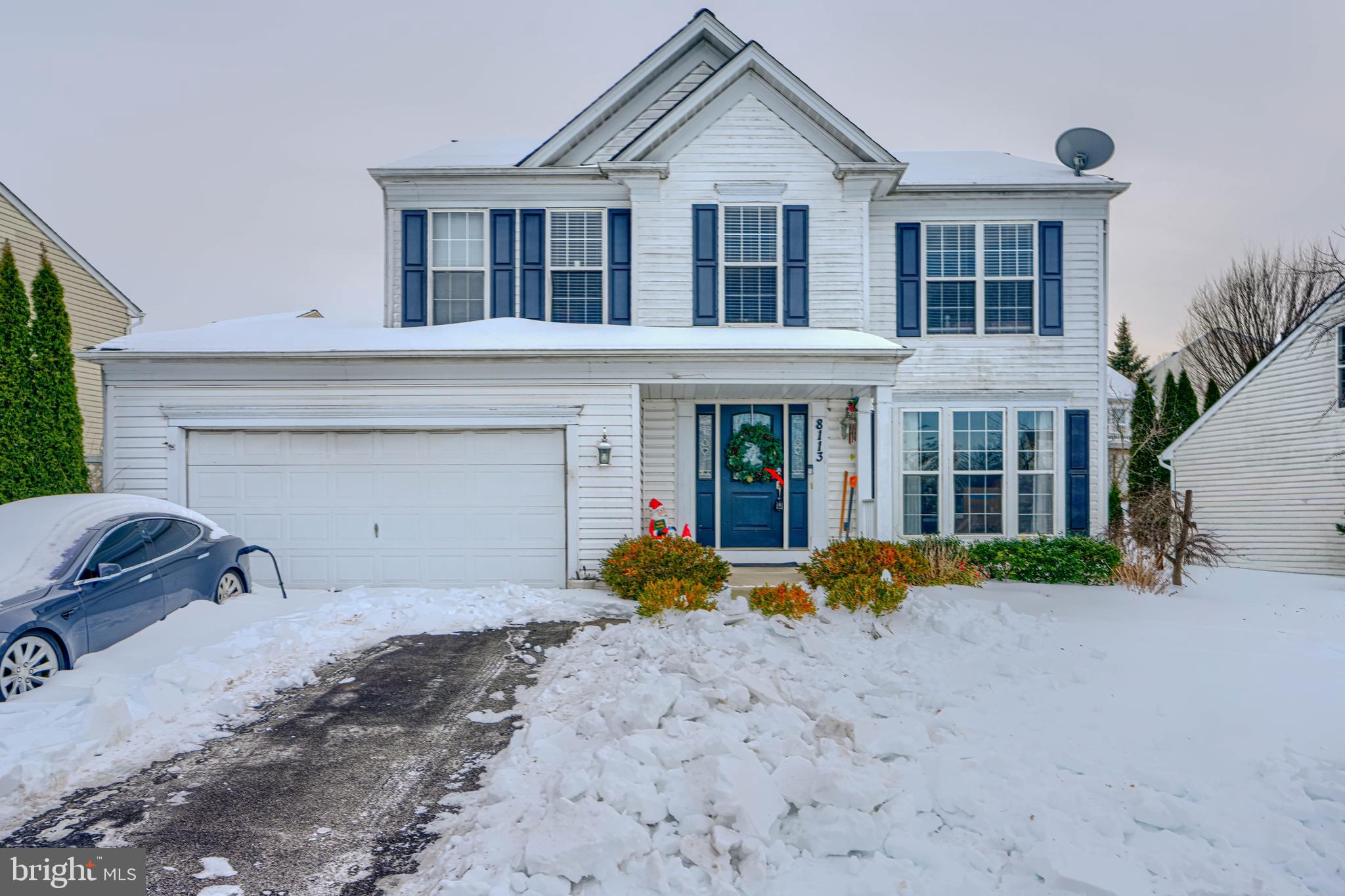 a front view of a house with garden and porch