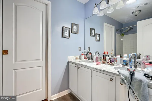 a bathroom with a sink vanity and mirror