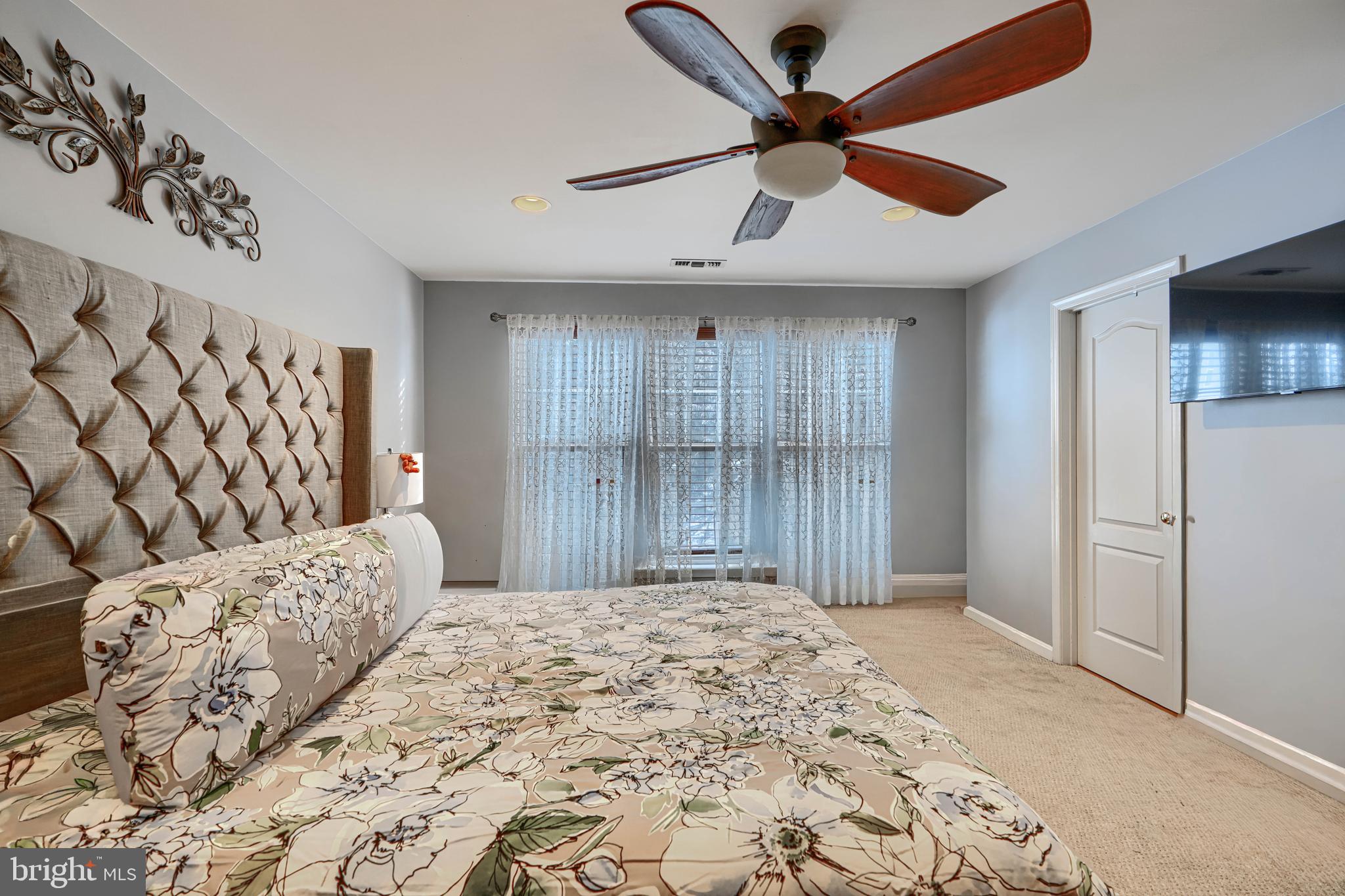 8113 Alan Tree Road Rosedale, MD 21237 - Photo 12 of 16 a bedroom with a large bed and a window