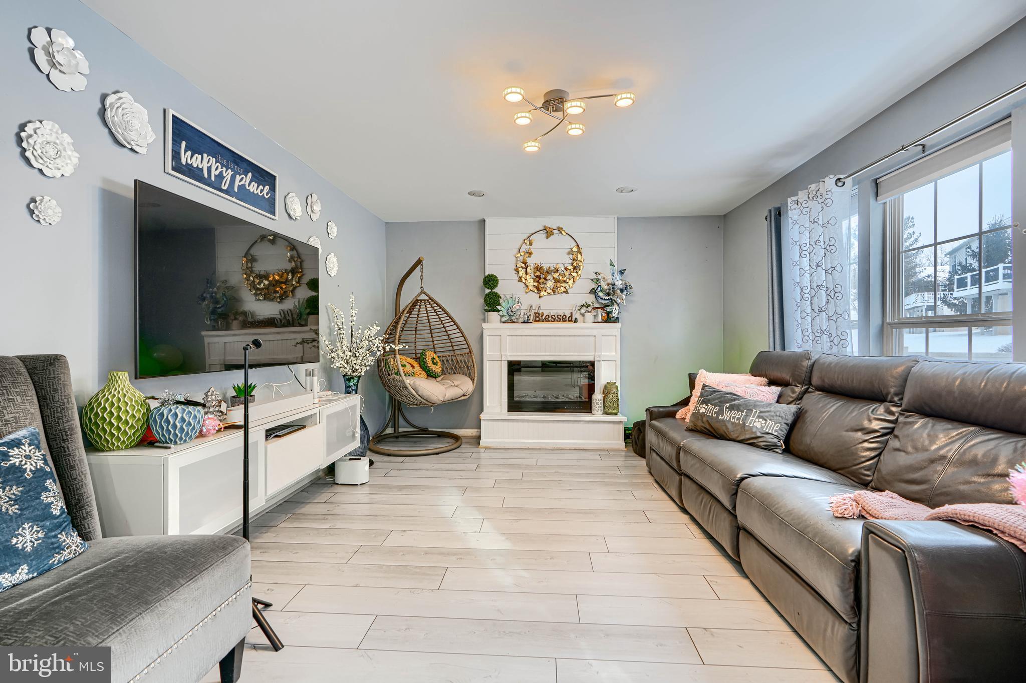 8113 Alan Tree Road Rosedale, MD 21237 - Photo 9 of 16 a living room with furniture and a fireplace