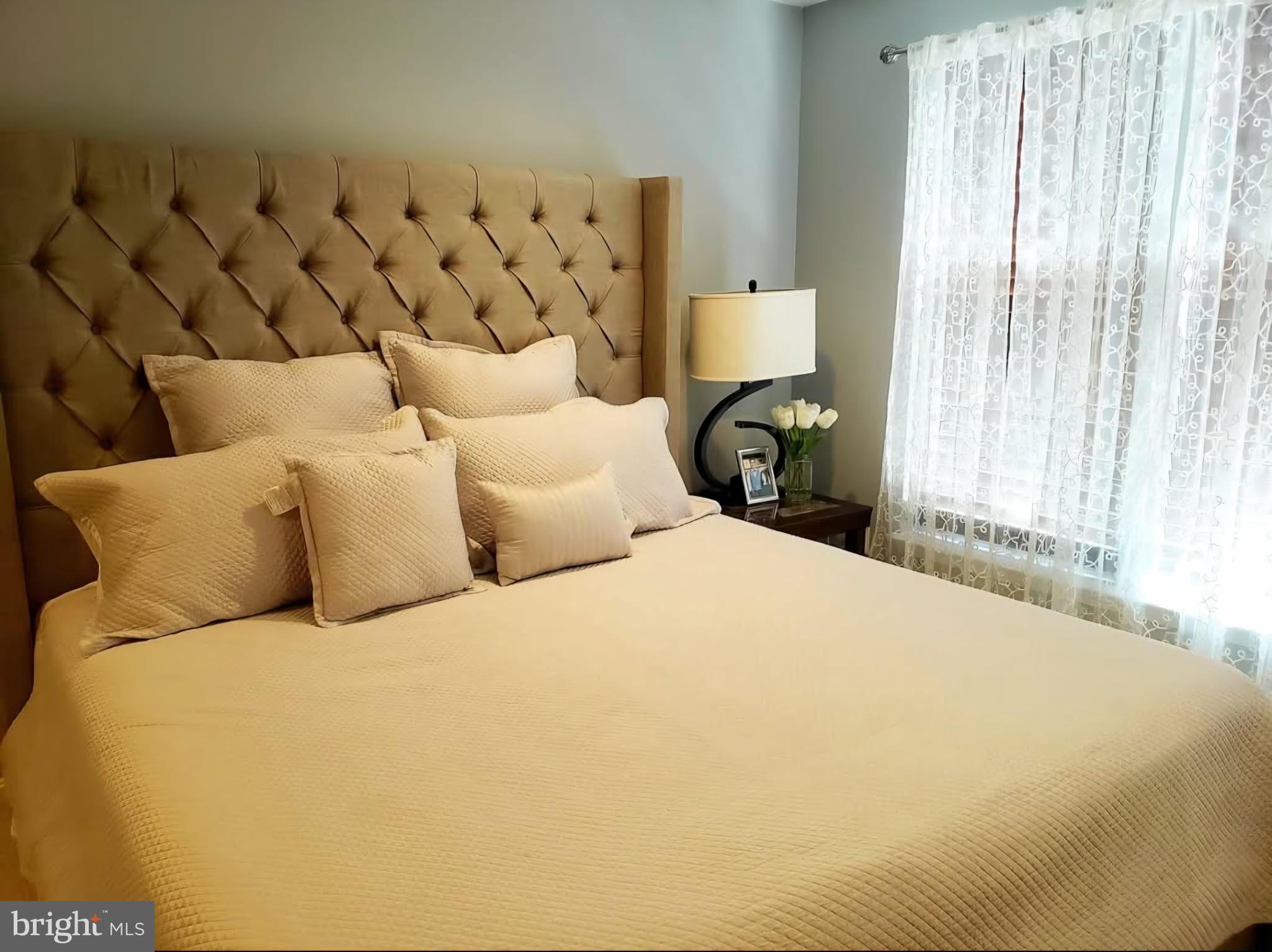 8113 Alan Tree Road Rosedale, MD 21237 - Photo 9 of 13 a bedroom with a bed and a window