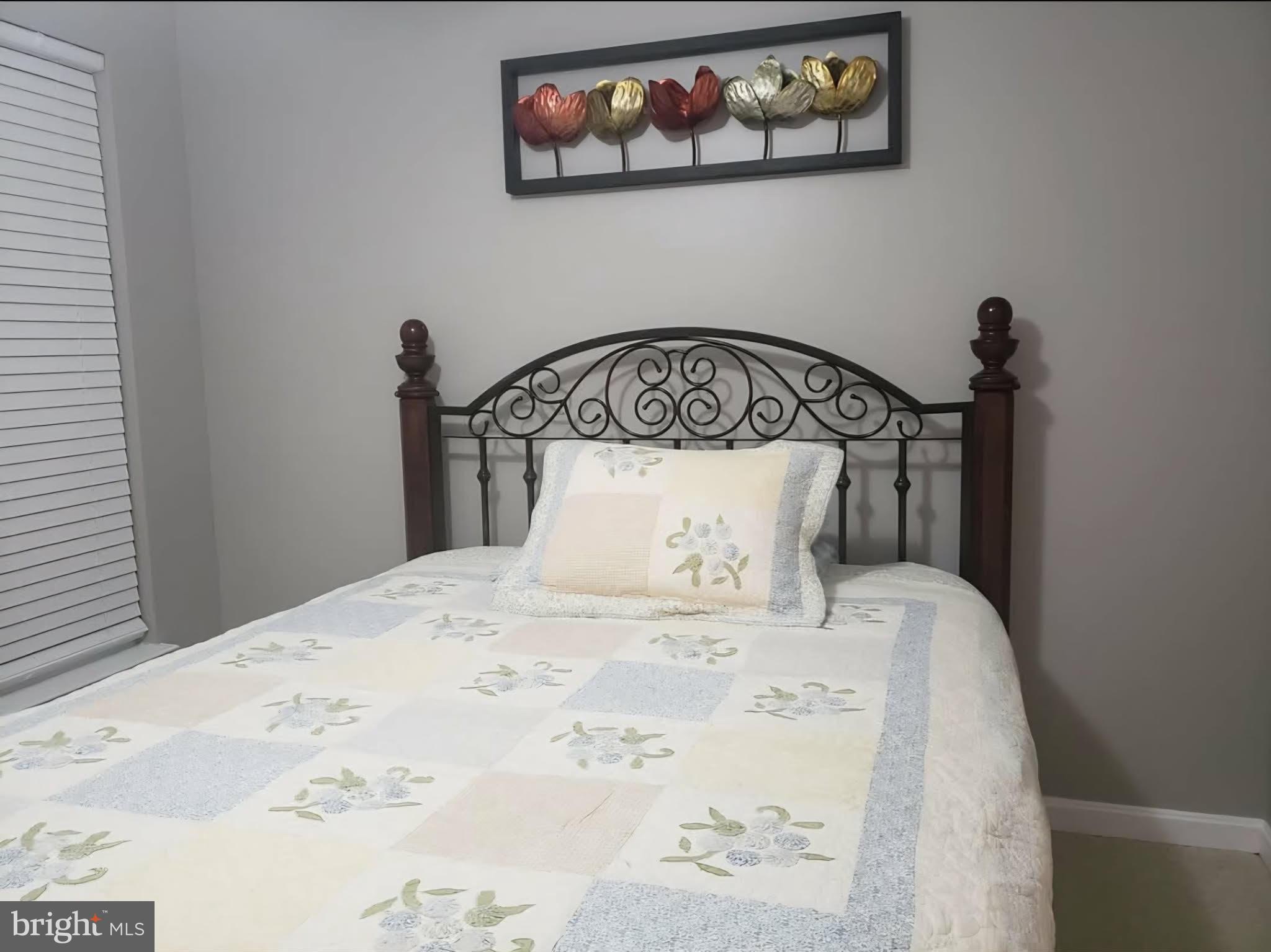 8113 Alan Tree Road Rosedale, MD 21237 - Photo 10 of 13 a bed with a bed and a table in it