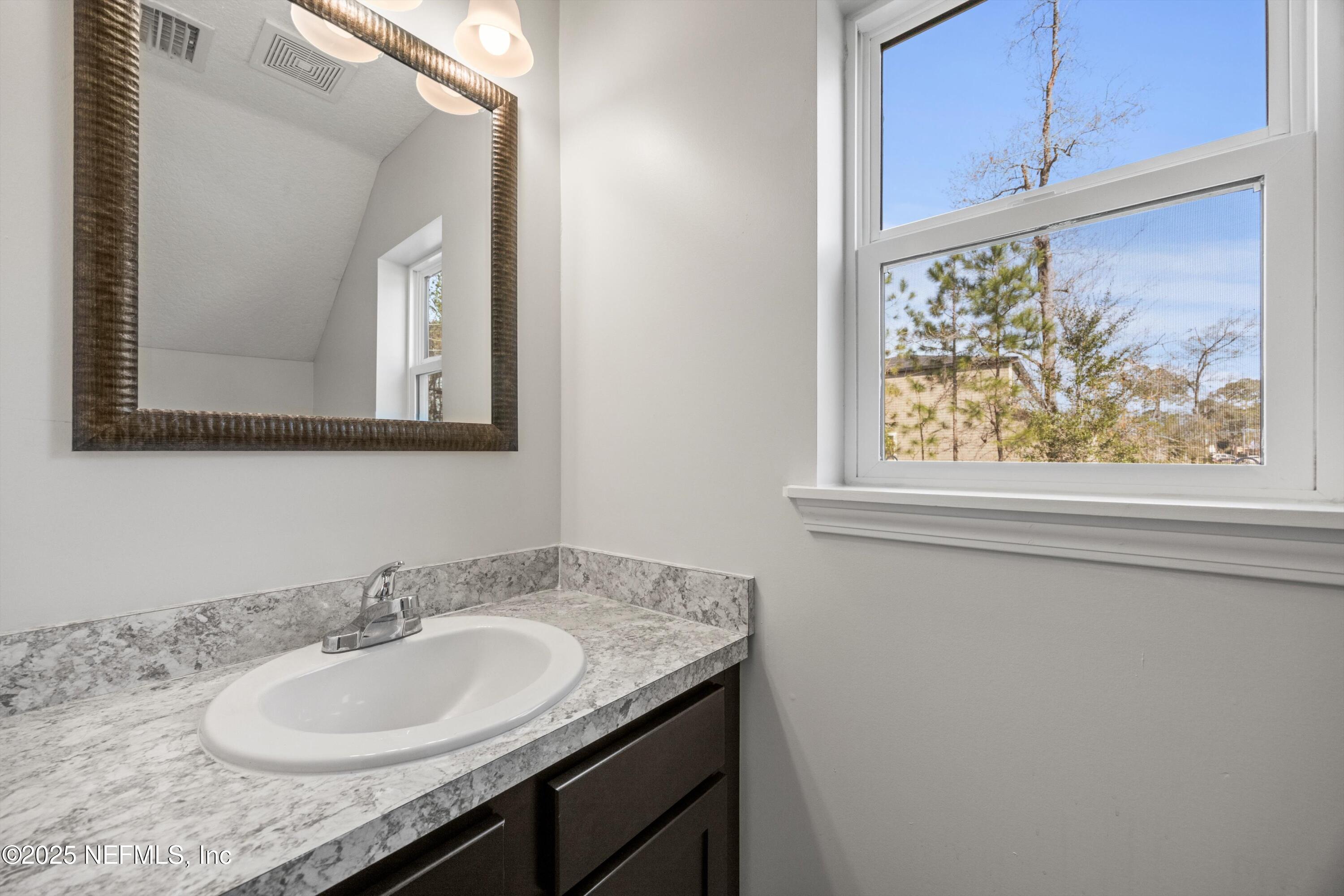 366 Old Jennings Road Orange Park, FL 32065 - Photo 18 of 40 a bathroom with a granite countertop sink and a mirror
