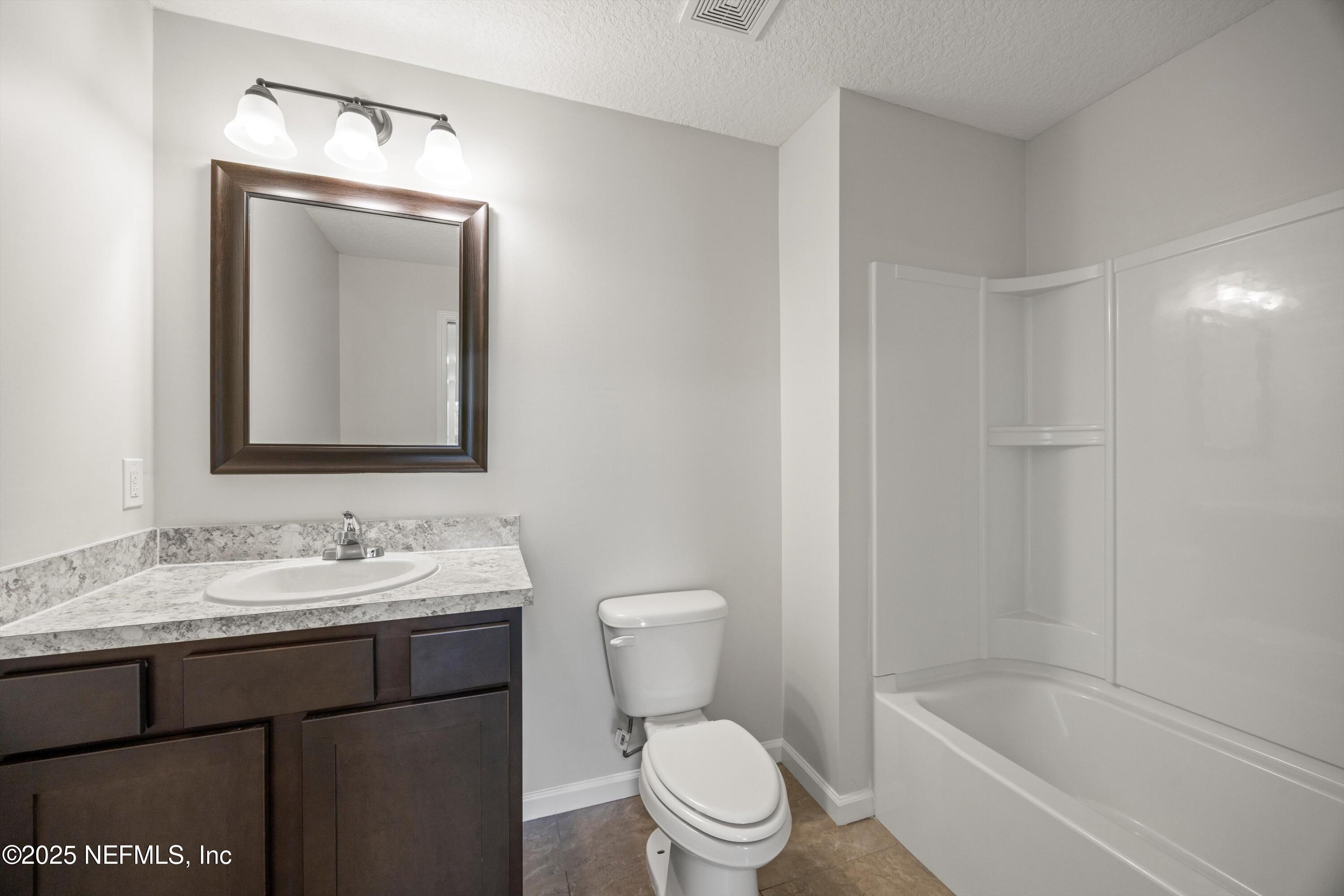 366 Old Jennings Road Orange Park, FL 32065 - Photo 28 of 40 a bathroom with a toilet a sink a bath tub and mirror