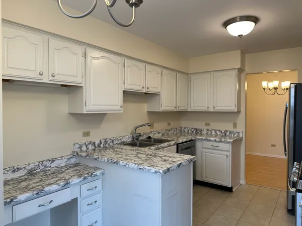 a kitchen with stainless steel appliances granite countertop a sink a stove and a refrigerator