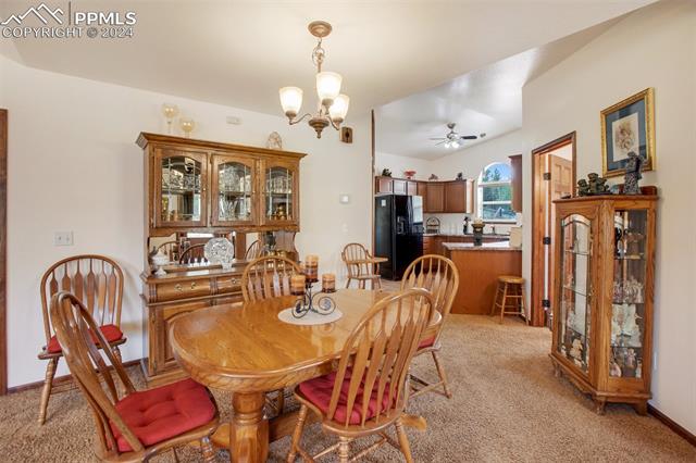 35 Cree Path Lake George, CO 80827 - Photo 10 of 46 Dining area with ceiling fan with notable chandelier and light carpet