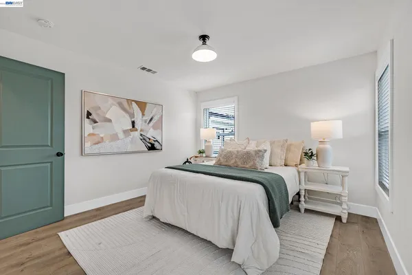 a bedroom with a bed and a large window