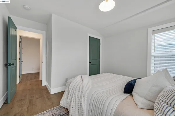 a bedroom with a bed and a chandelier