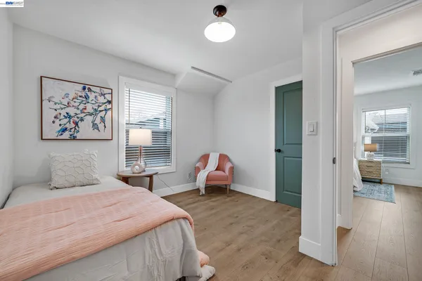a view of a house with a yard and wooden fence