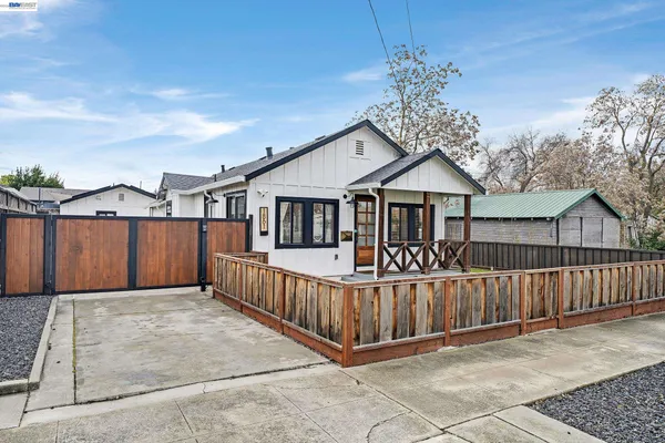a view of a house with wooden fence