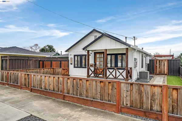 a view of a house with wooden fence