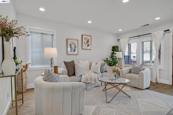 a living room with furniture and a potted plant