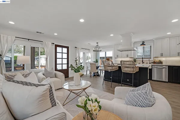 a kitchen with kitchen island a white stove top oven and refrigerator