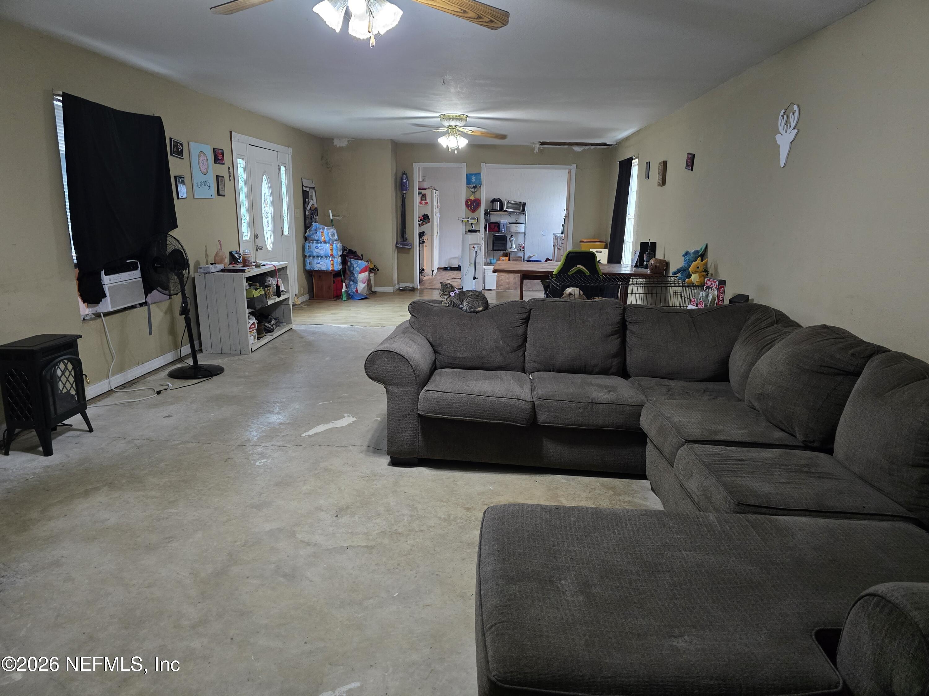 113 Tyre Road Interlachen, FL 32148 - Photo 6 of 15 a living room with furniture and a flat screen tv