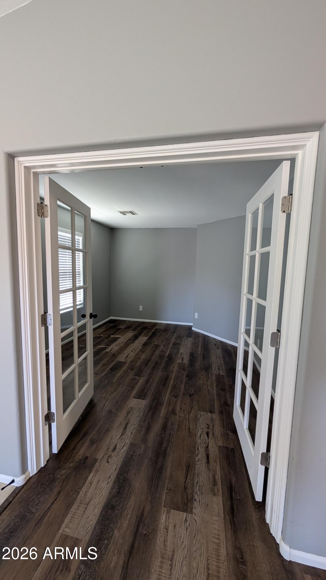 1377 East Pryor Road San Tan Valley, AZ 85140 - Photo 15 of 31 a view of an empty room with wooden floor and a window