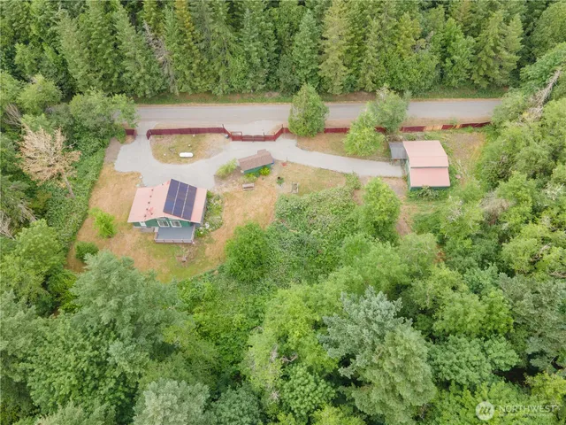 an aerial view of a house with a yard
