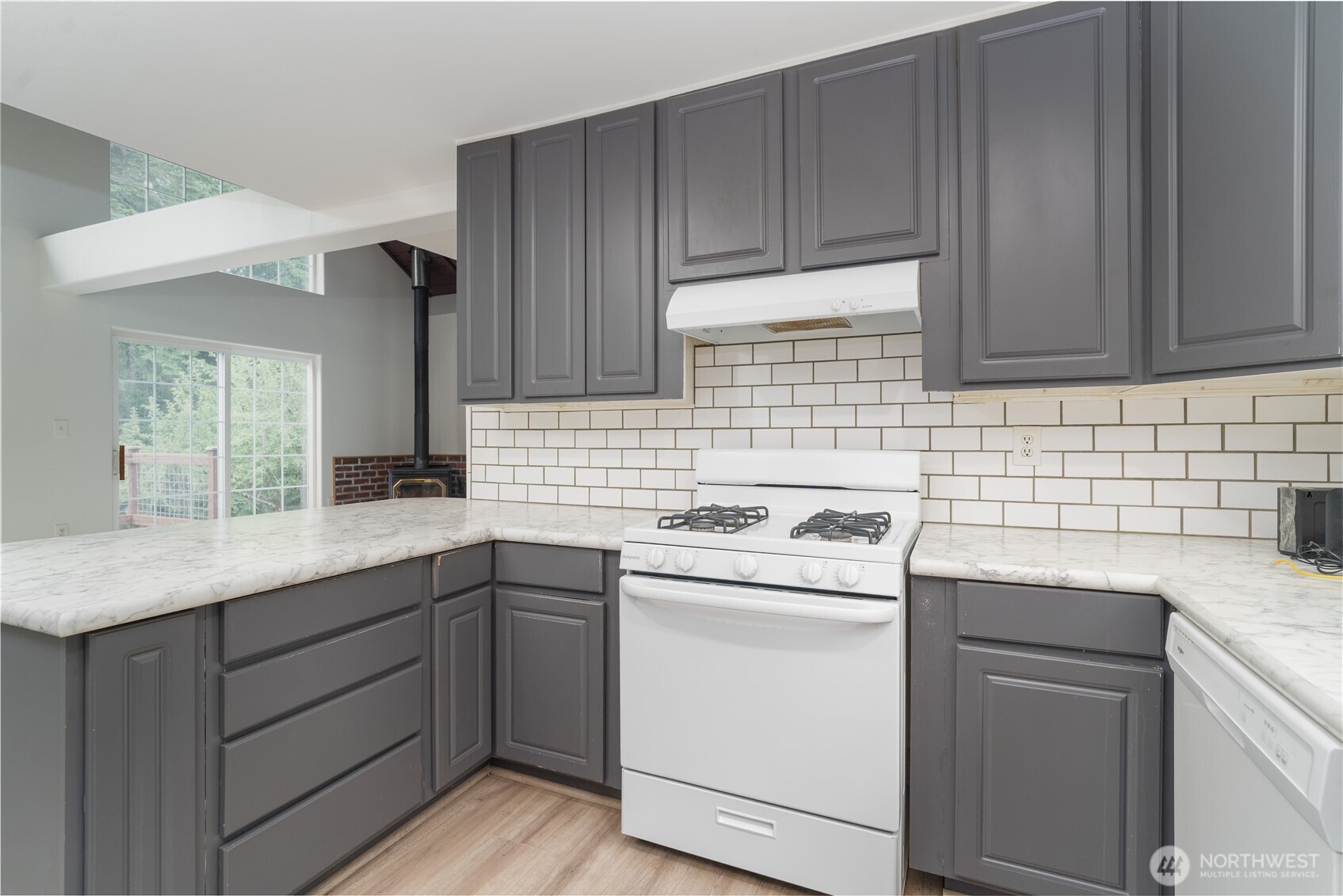 21405 Thompson Creek Road Southeast Tenino, WA 98589 - Photo 11 of 26 a kitchen with a sink stove and cabinets