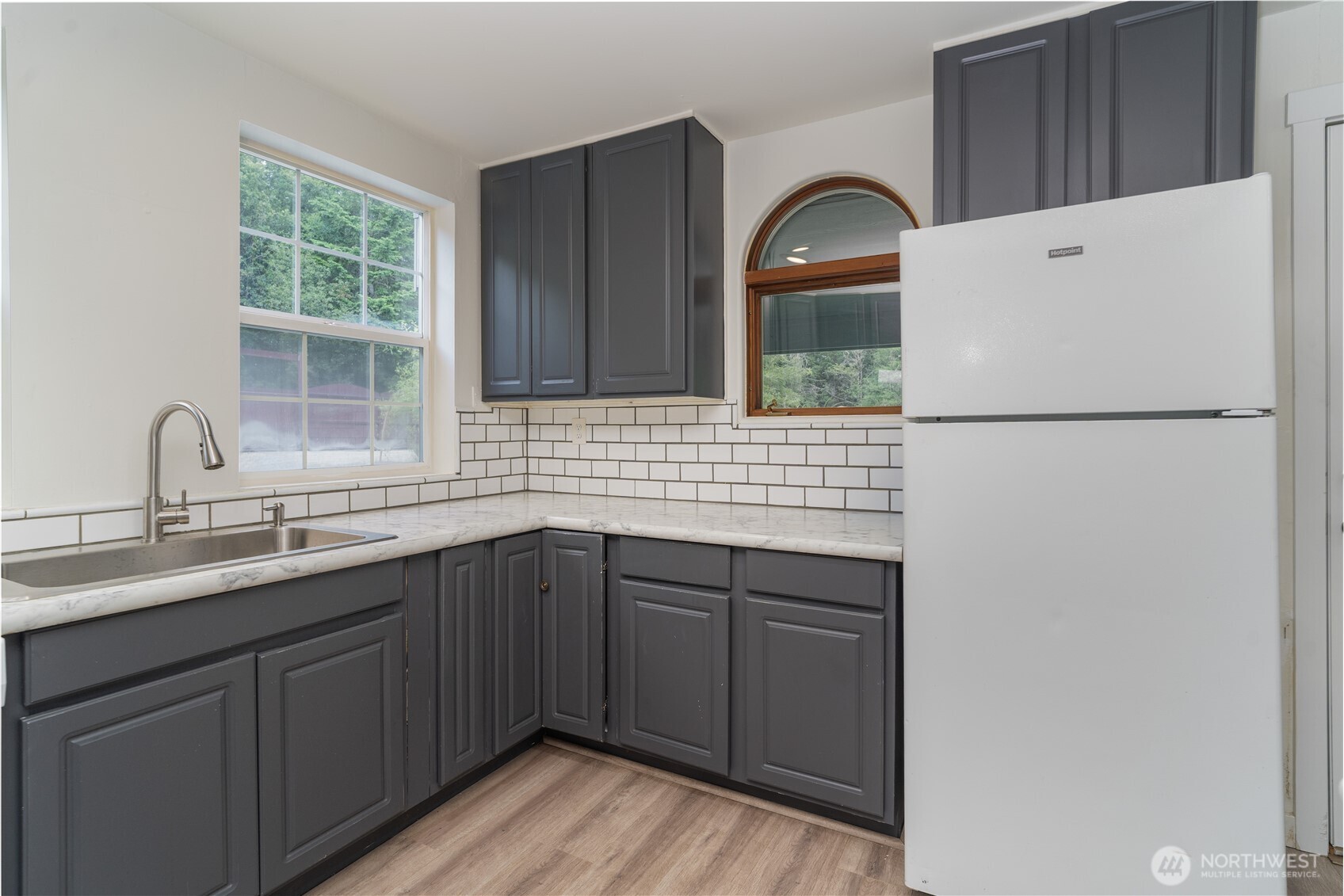 21405 Thompson Creek Road Southeast Tenino, WA 98589 - Photo 12 of 26 a kitchen with a sink cabinets and window