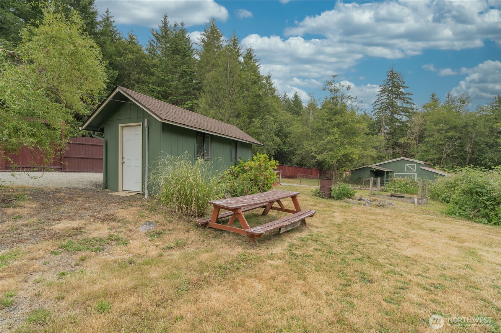 21405 Thompson Creek Road Southeast Tenino, WA 98589 - Photo 21 of 26 a backyard of a house with table and chairs