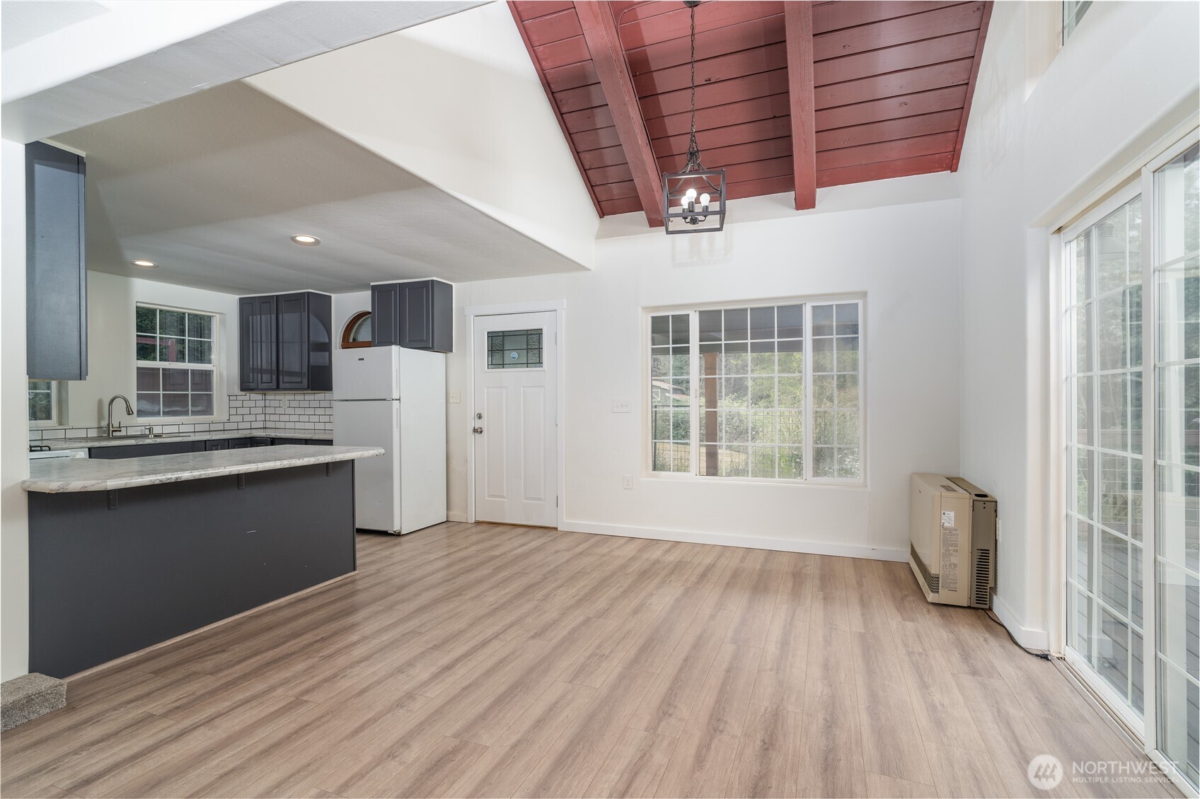 21405 Thompson Creek Road Southeast Tenino, WA 98589 - Photo 8 of 26 a view of a kitchen with a sink and dishwasher with wooden floor