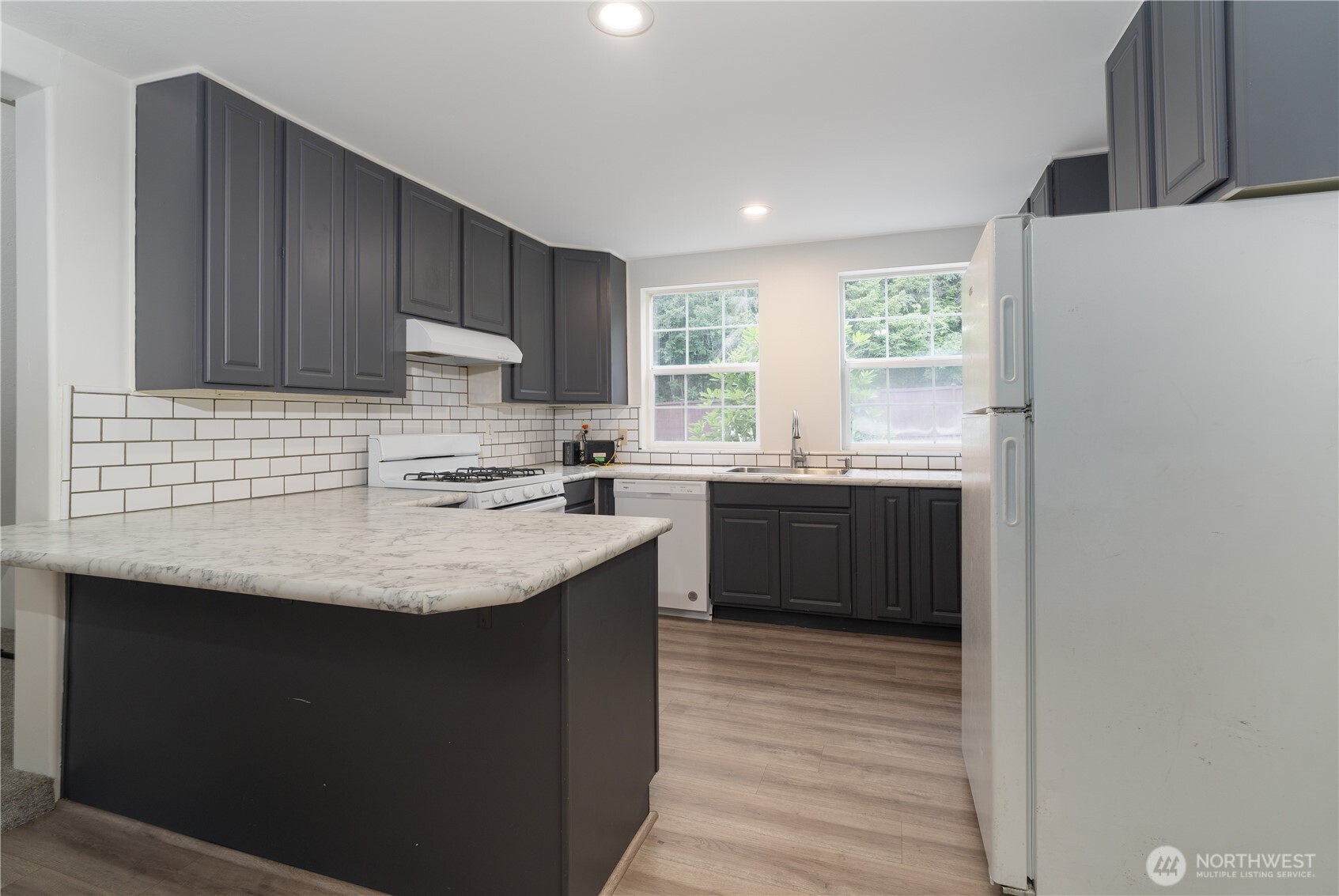 21405 Thompson Creek Road Southeast Tenino, WA 98589 - Photo 10 of 26 a kitchen with stainless steel appliances granite countertop a sink stove and refrigerator